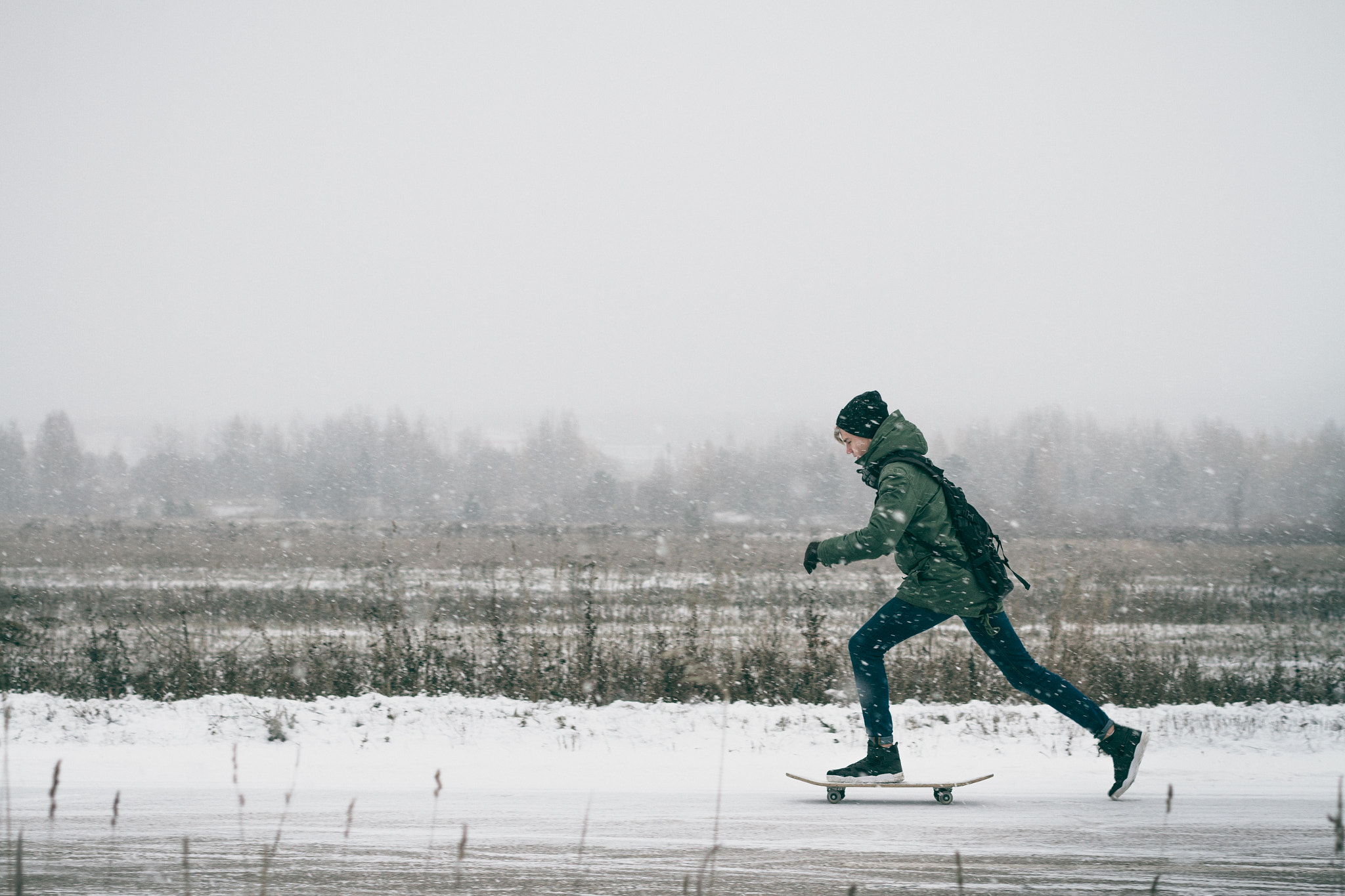 Canon EF 50mm F2.5 Macro sample photo. A young boy riding his skateboard in the winter. photography