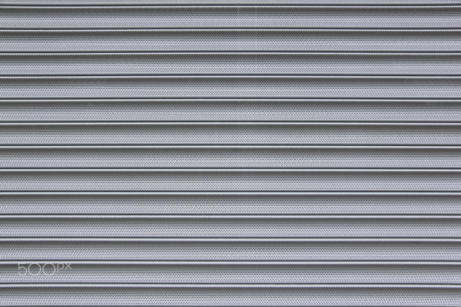 Canon EF-S 17-85mm F4-5.6 IS USM sample photo. Perforated metal security shutter background photography