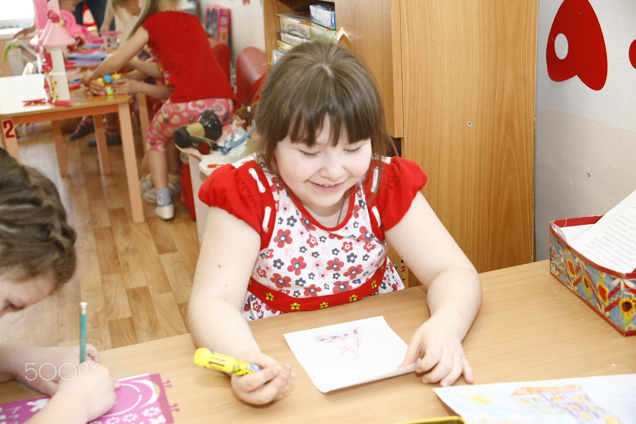 MOSCOW, RUSSIA-APRIL 17, 2014: children play with toys and engage  the tutor in a kindergarten