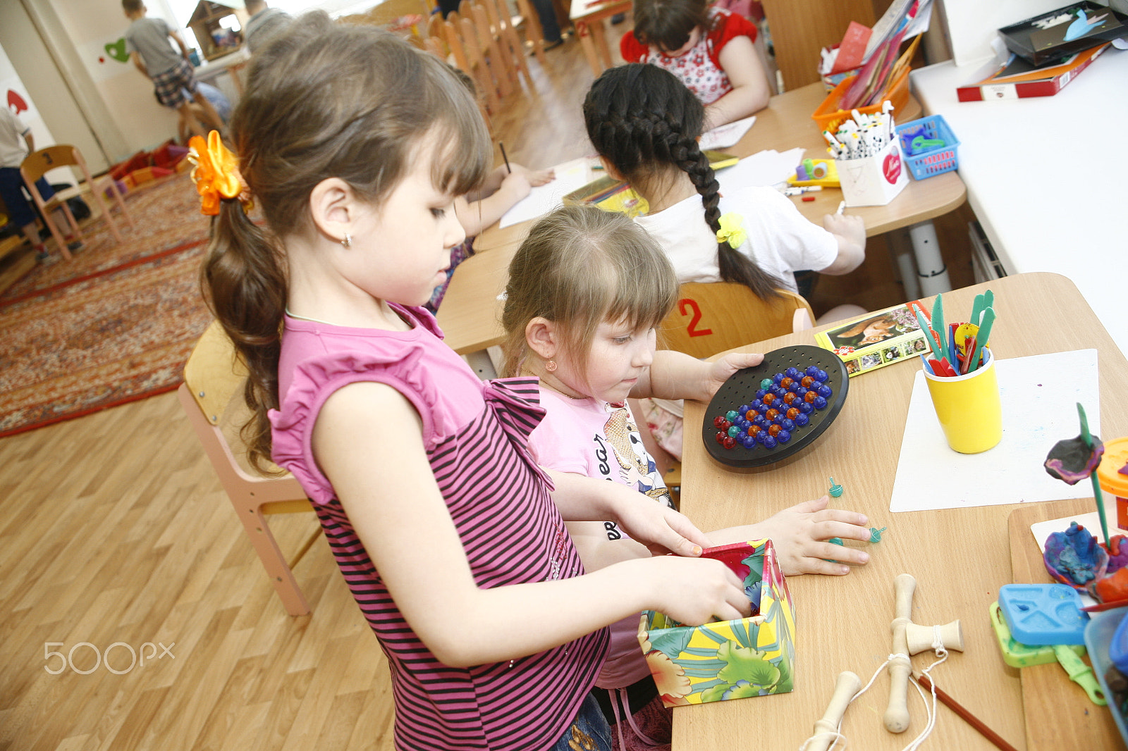 Canon EF 28-105mm f/3.5-4.5 USM sample photo. Moscow, russia-april 17, 2014: children play with toys and engage  the tutor in a kindergarten photography