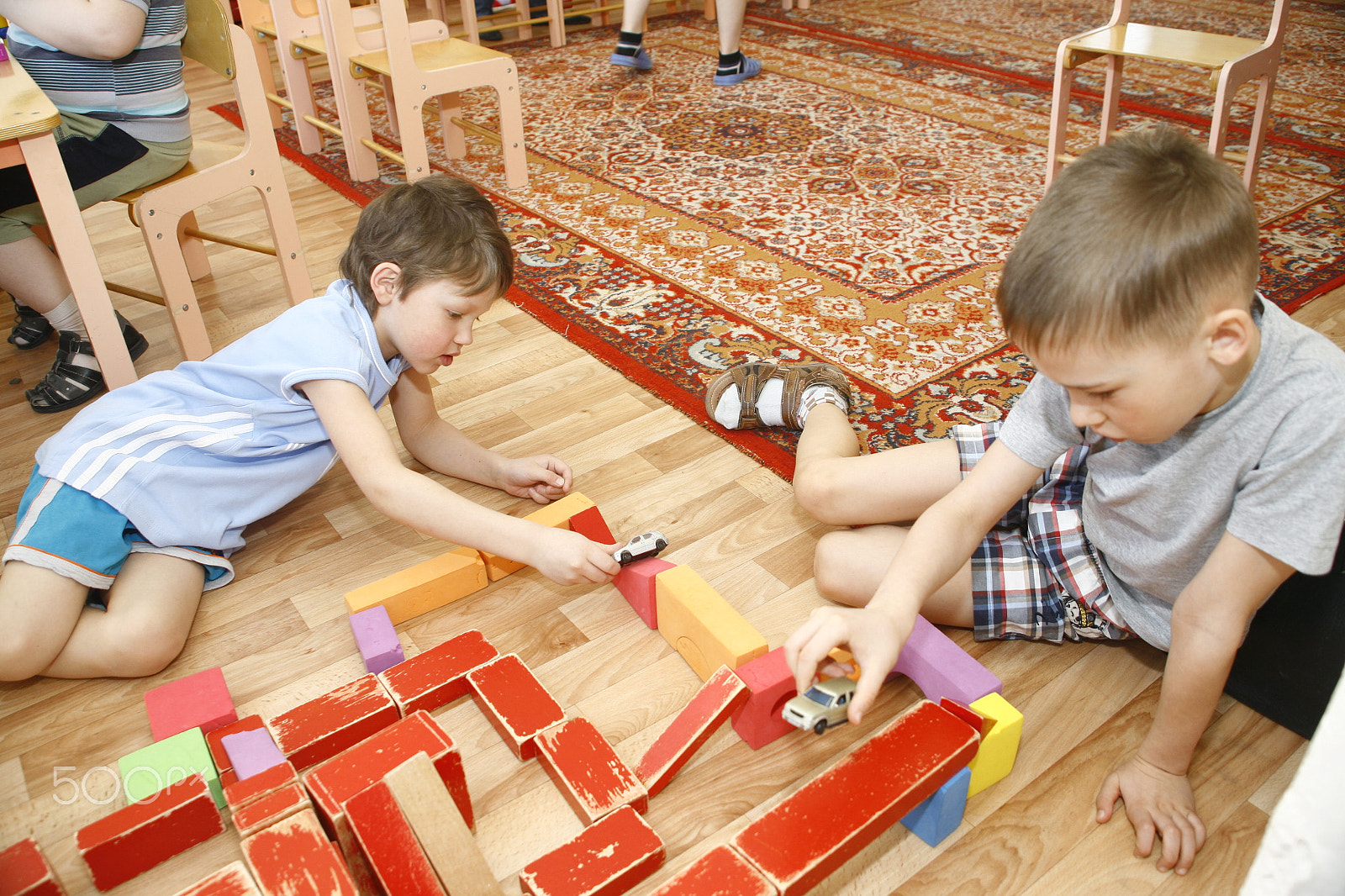 Canon EOS 5D sample photo. Moscow, russia-april 17, 2014: children play with toys and engage  the tutor in a kindergarten photography
