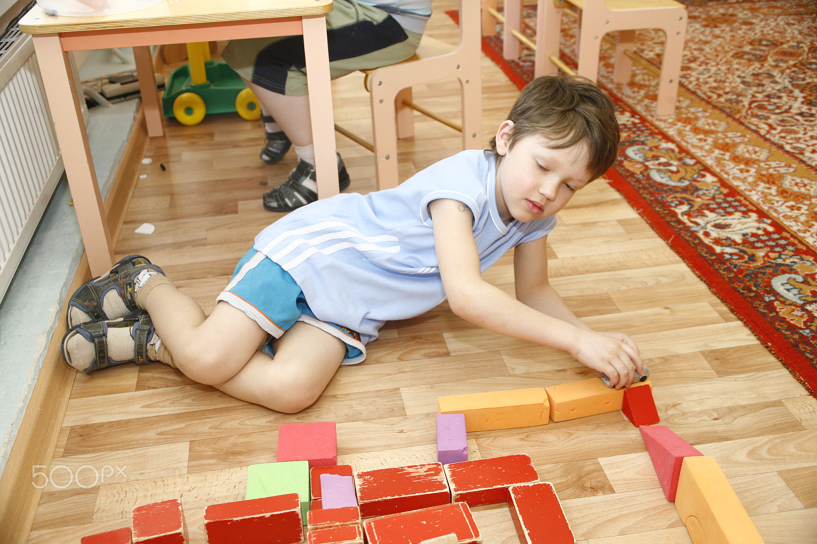 Canon EF 28-105mm f/3.5-4.5 USM sample photo. Moscow, russia-april 17, 2014: children play with toys and engage  the tutor in a kindergarten photography
