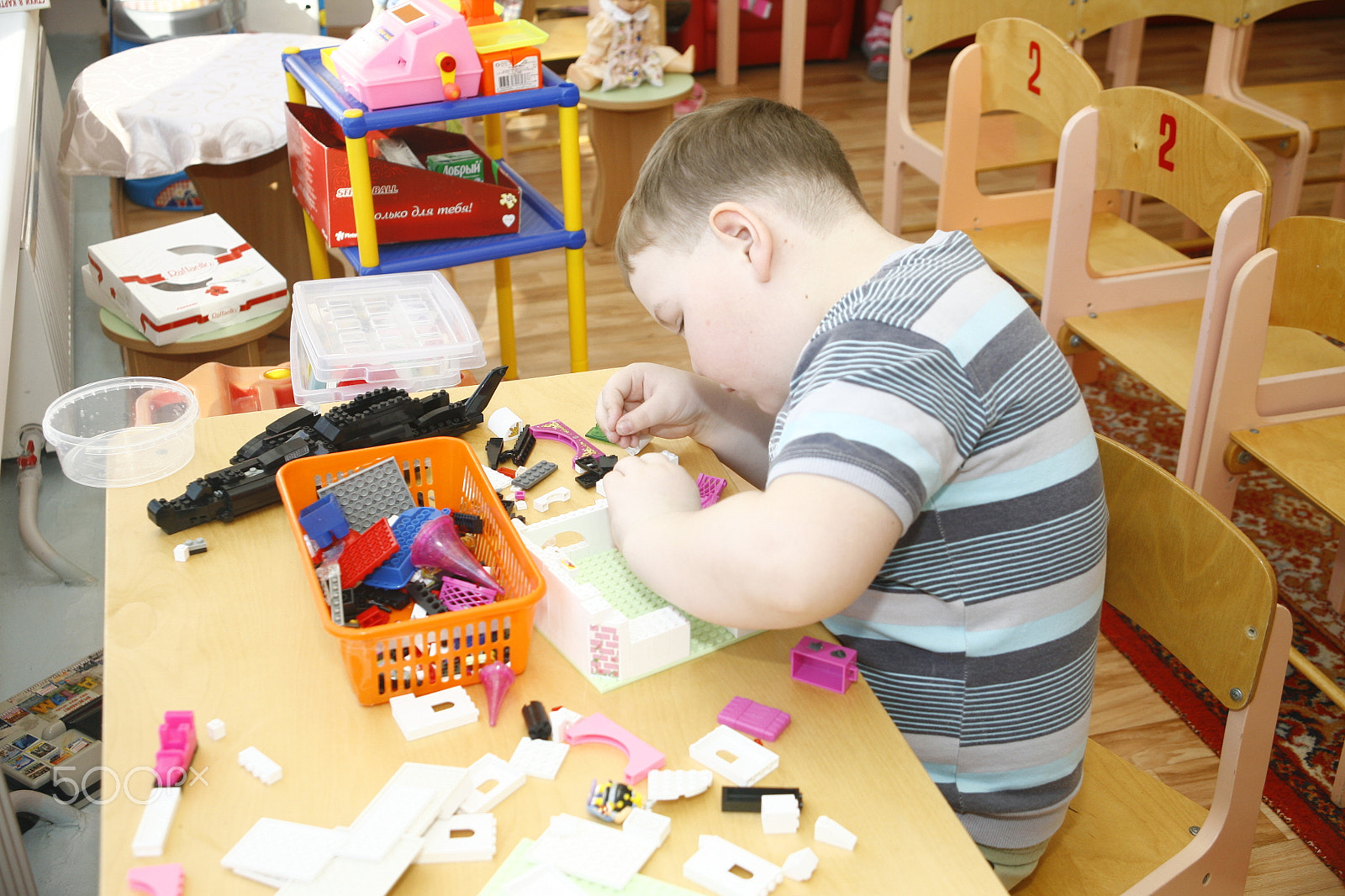 Canon EF 28-105mm f/3.5-4.5 USM sample photo. Moscow, russia-april 17, 2014: children play with toys and engage  the tutor in a kindergarten photography