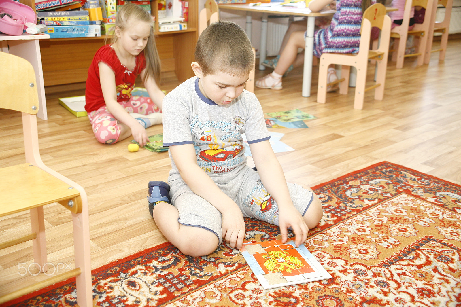 Canon EF 28-105mm f/3.5-4.5 USM sample photo. Moscow, russia-april 17, 2014: children play with toys and engage  the tutor in a kindergarten photography