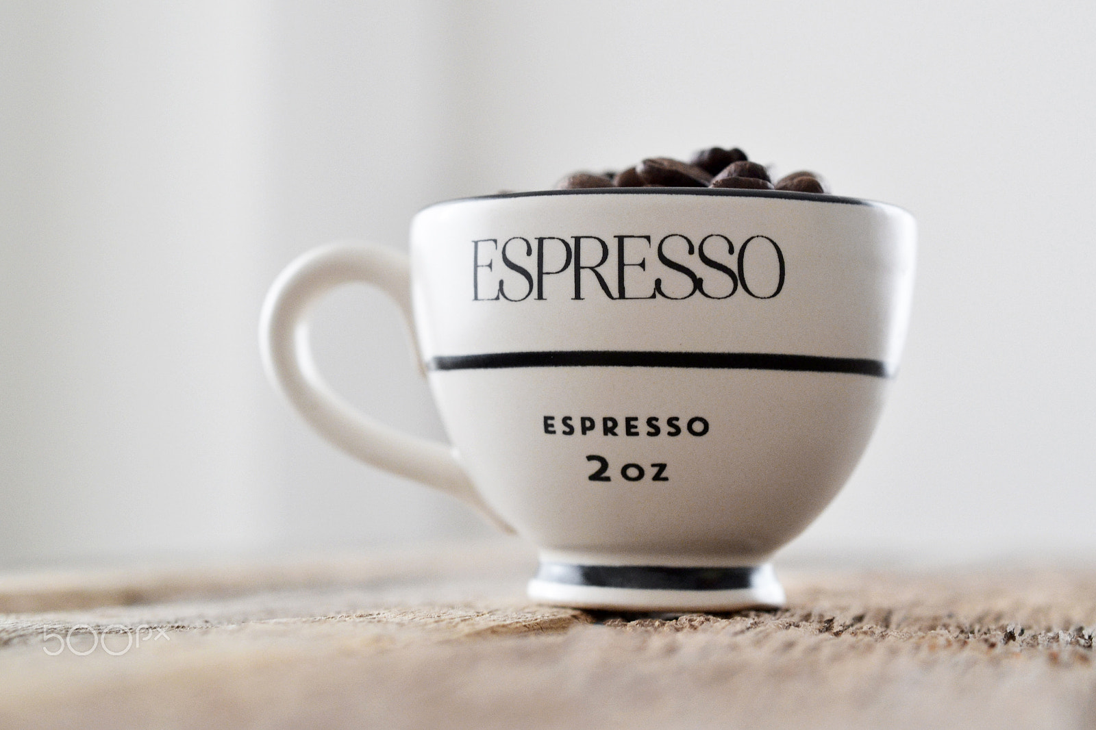 Nikon AF-S DX Micro Nikkor 40mm F2.8 sample photo. Coffee beans in espresso cup on wood table photography