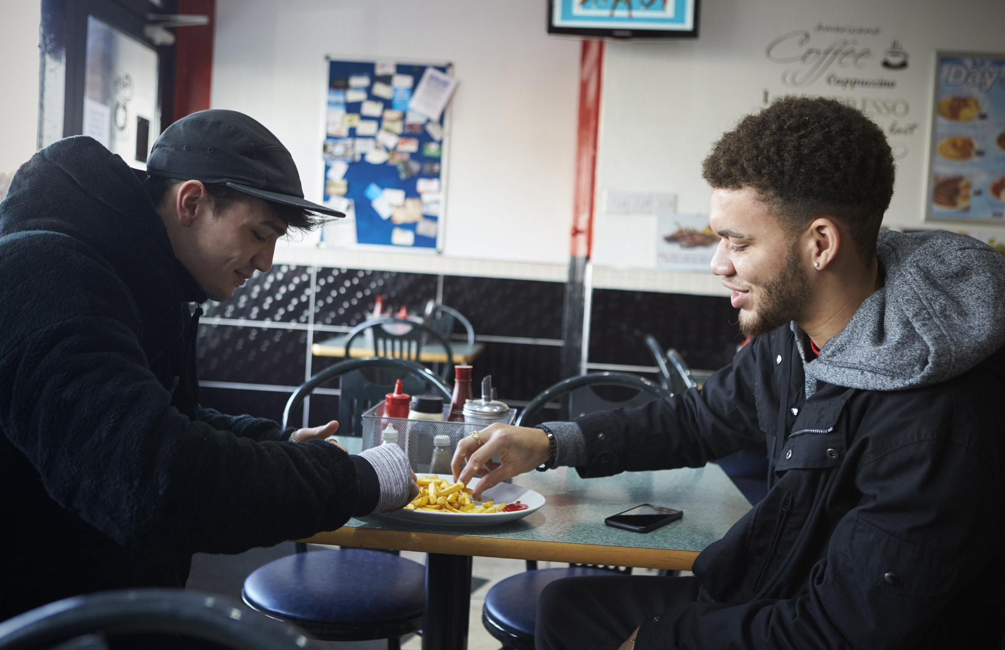 Canon EOS-1D X sample photo. Two male students eating meal in café photography