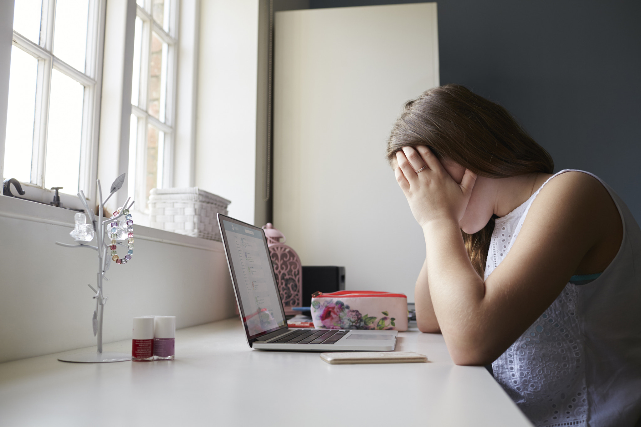 Unhappy Teenage Victim Of Online Bullying In Bedroom