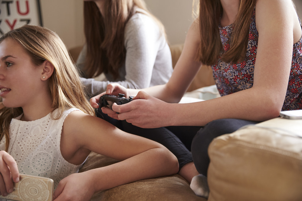 Group Of Teenage Girls Playing Video Game In Bedroom by Guerilla Images on 500px.com