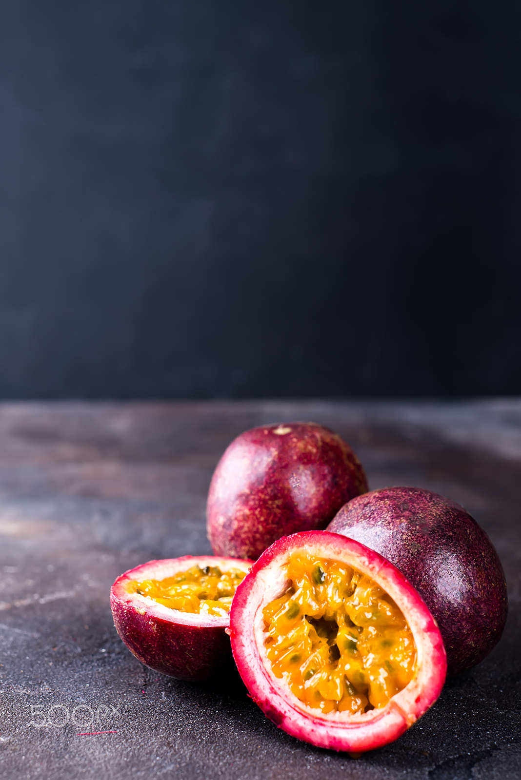 AF Nikkor 50mm f/1.8 sample photo. Passion fruits on dark table photography