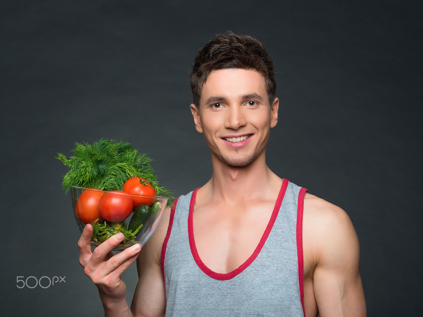 Panasonic Lumix DMC-GH4 sample photo. Young fitted trainer and nutritionist holding a bowl of vegetables photography