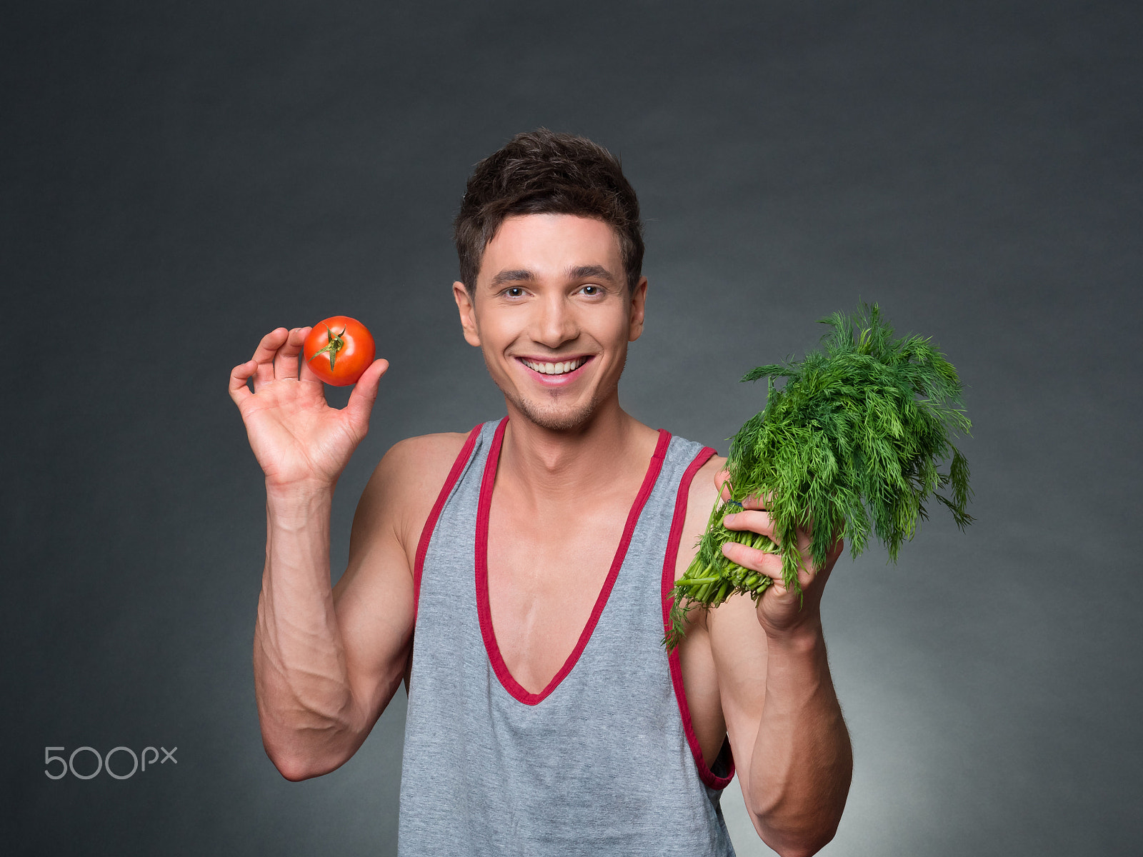 Panasonic Lumix DMC-GH4 + Panasonic Lumix G 42.5mm F1.7 ASPH Power OIS sample photo. Young fitted trainer and nutritionist holding a bowl of vegetables photography