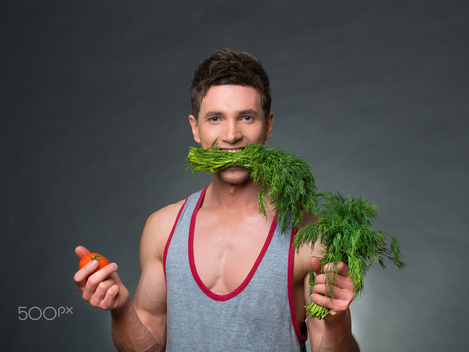 Panasonic Lumix DMC-GH4 sample photo. Young fitted trainer and nutritionist holding a bowl of vegetables photography