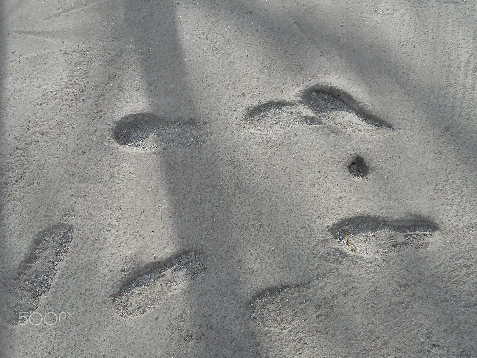Nikon Coolpix S2900 sample photo. Traces of human feet in shoes in a frozen cement photography