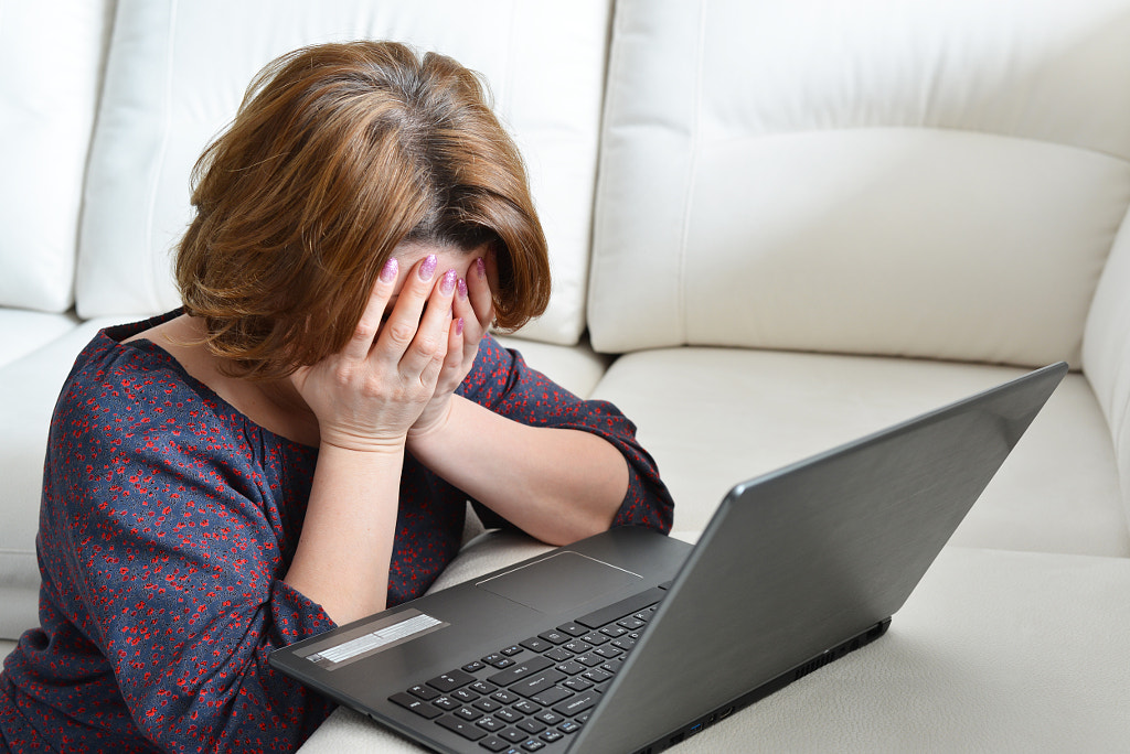 frustrated woman at a laptop at home by Ольга Володина on 500px.com