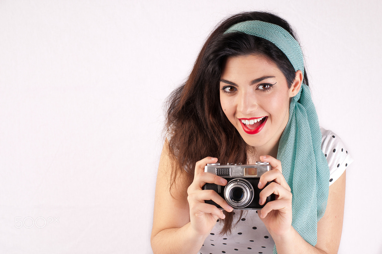 Nikon D300S + Nikon AF-S Nikkor 50mm F1.8G sample photo. Pinup girl smiling with a camera in hands photography