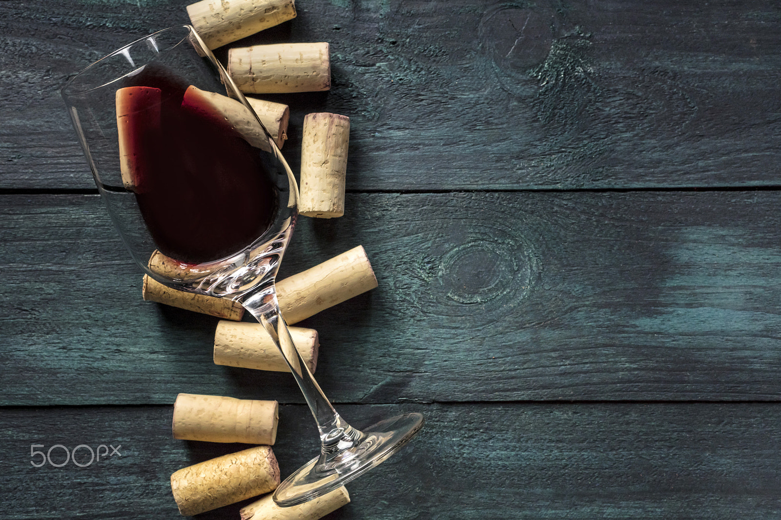 Canon EOS 5DS R sample photo. Glass of red wine and corks on dark background photography