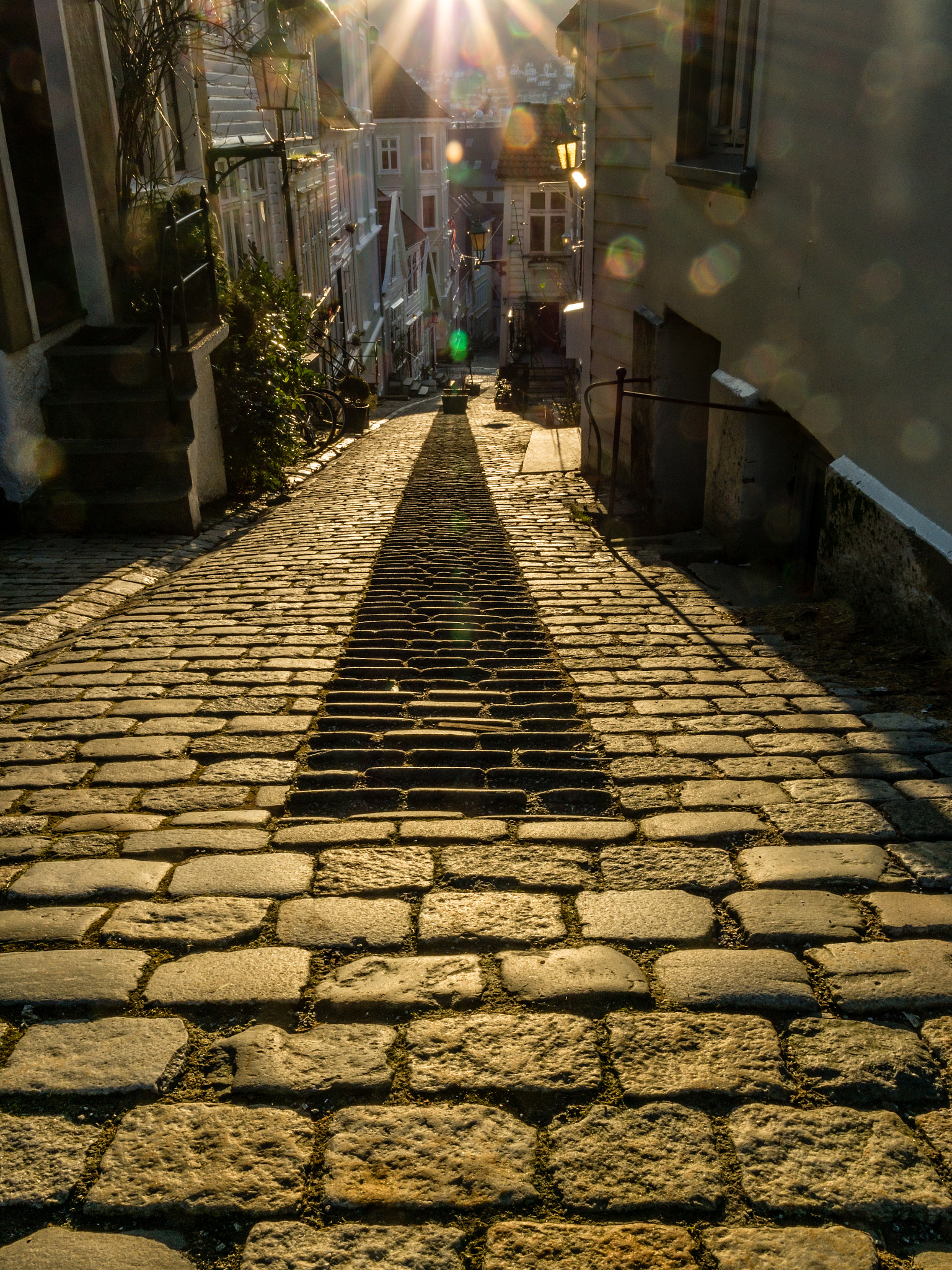 Samsung NX 18-55mm F3.5-5.6 OIS sample photo. "backlit cobblestones and sunflare" photography