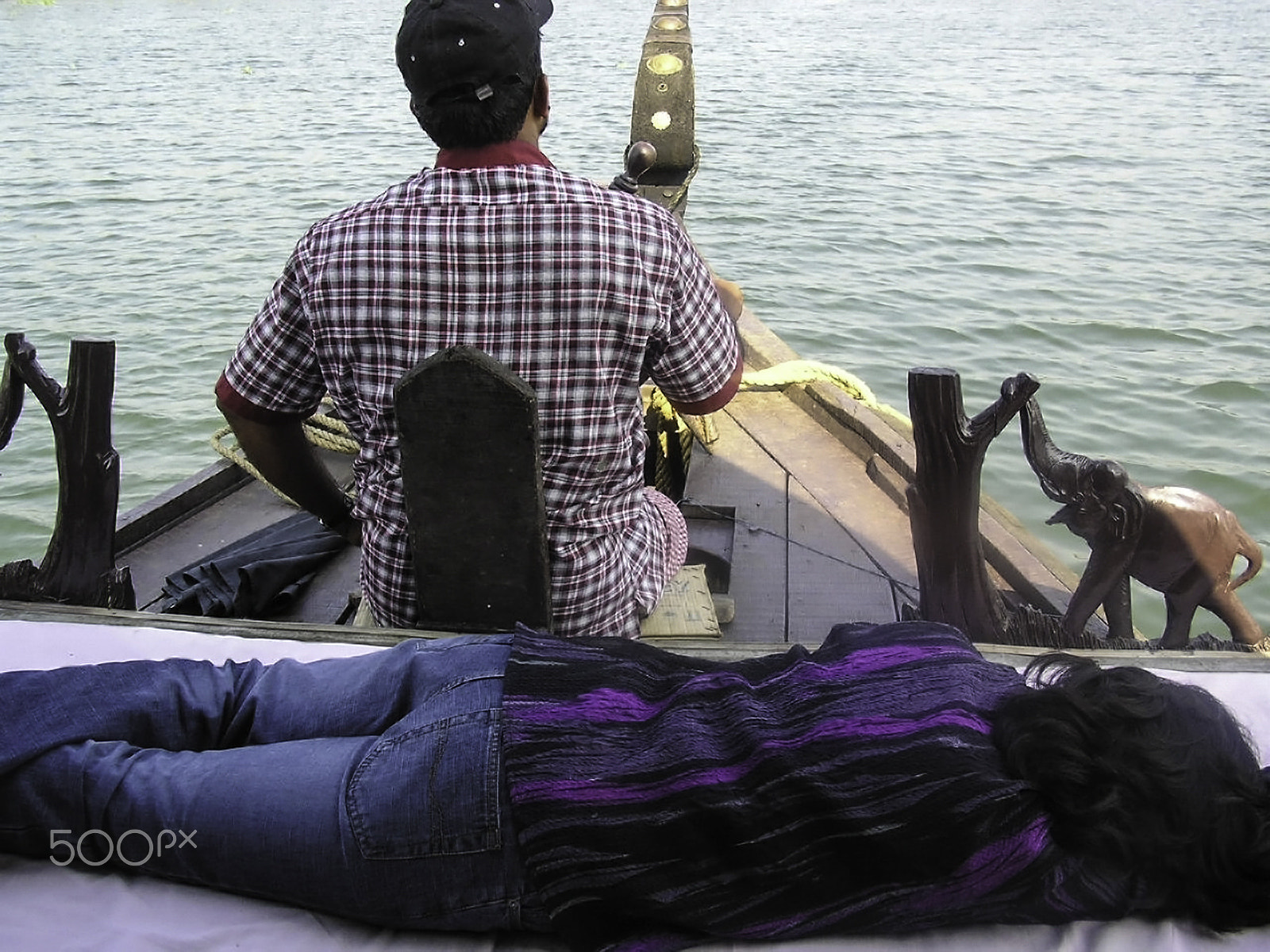 Olympus C750UZ sample photo. Lady sleeping while boatman steers photography