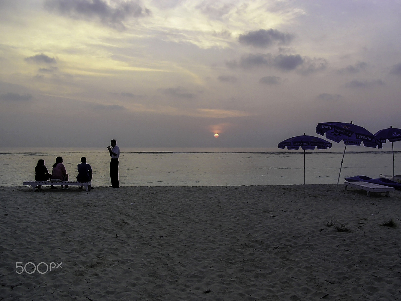 Olympus C750UZ sample photo. Host gesturing to a tourist family at sunrise in the lakshadweep photography