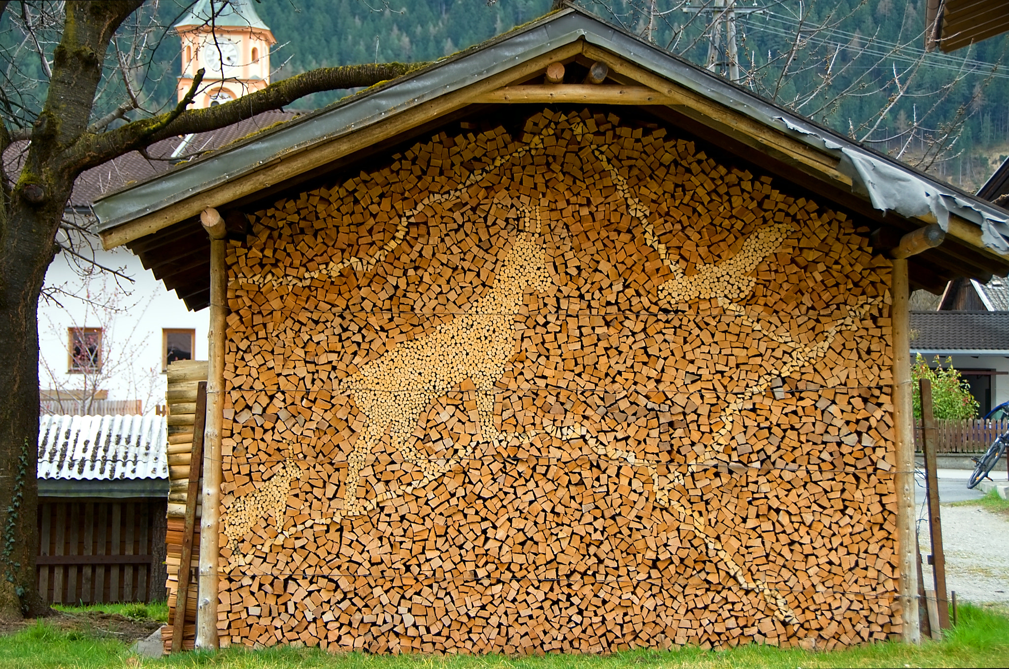18.00 - 200.00 mm f/3.5 - 5.6 sample photo. Wood pile with coat of arms tyrol austria photography