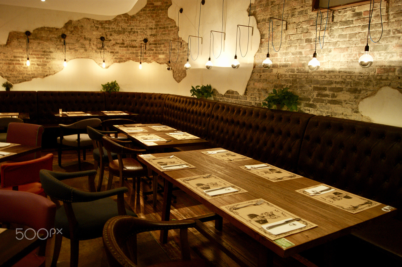 Sony DT 18-55mm F3.5-5.6 SAM II sample photo. Neat tables after business hours with warm lights photography