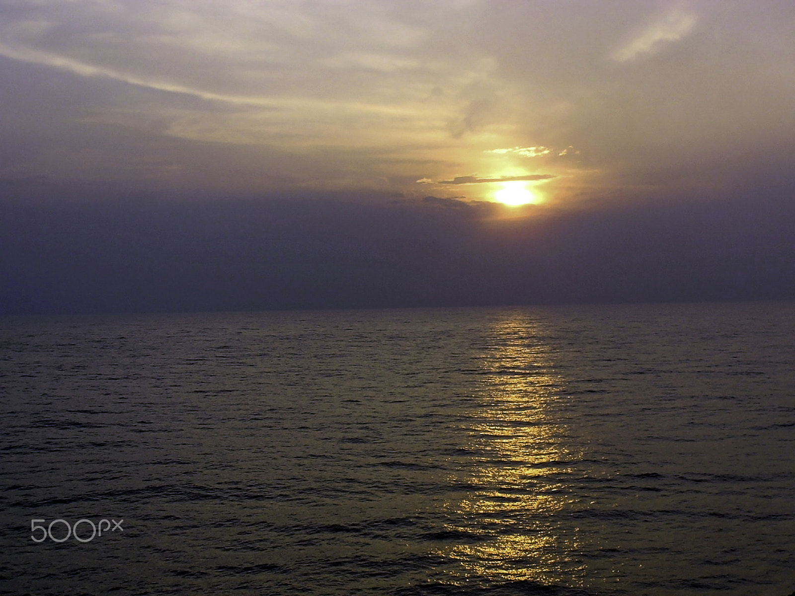 Olympus C750UZ sample photo. View of sunset through clouds and over the water of the arabian photography