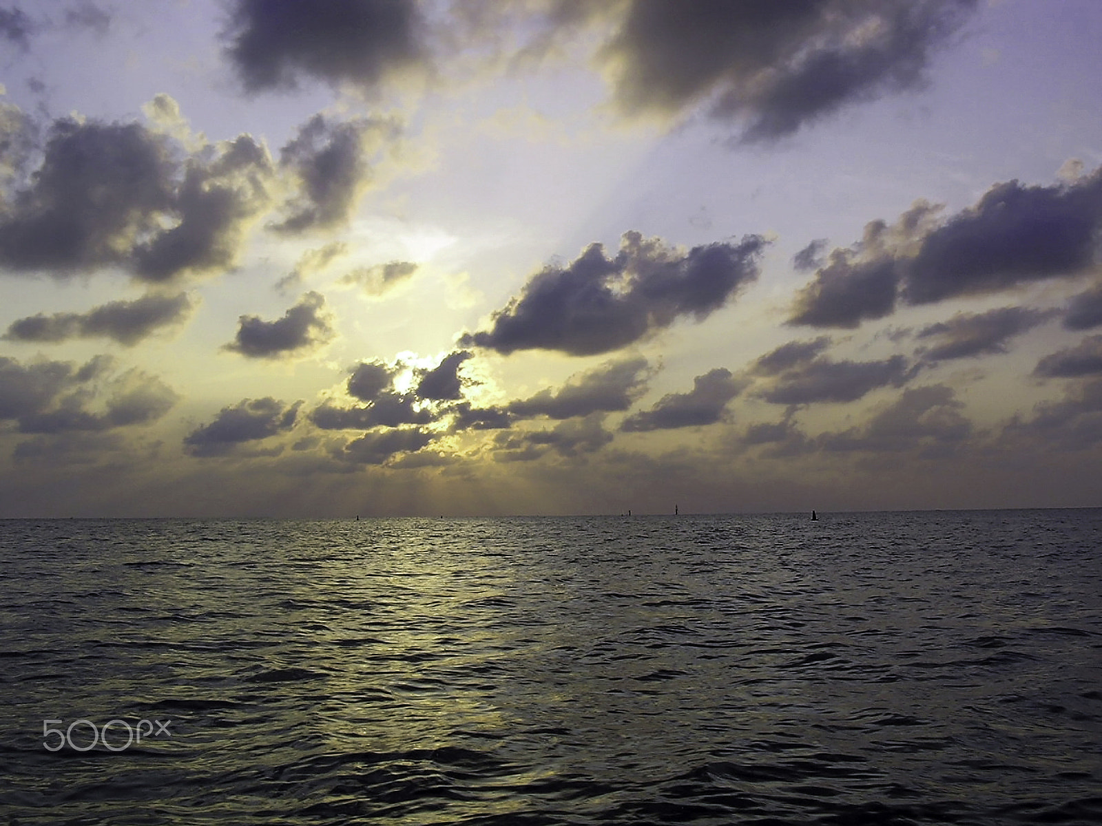 Olympus C750UZ sample photo. Sunset through the clouds over the water of the arabian sea off photography