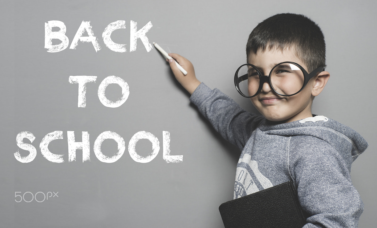 Sony a7 + Sony DT 50mm F1.8 SAM sample photo. Boy with glasses and funny gesture writing on the blackboard the photography