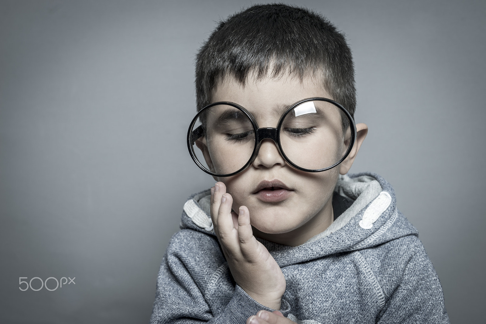 Sony a7 + Sony DT 50mm F1.8 SAM sample photo. Dark-haired young student with big glasses thinking gesture photography