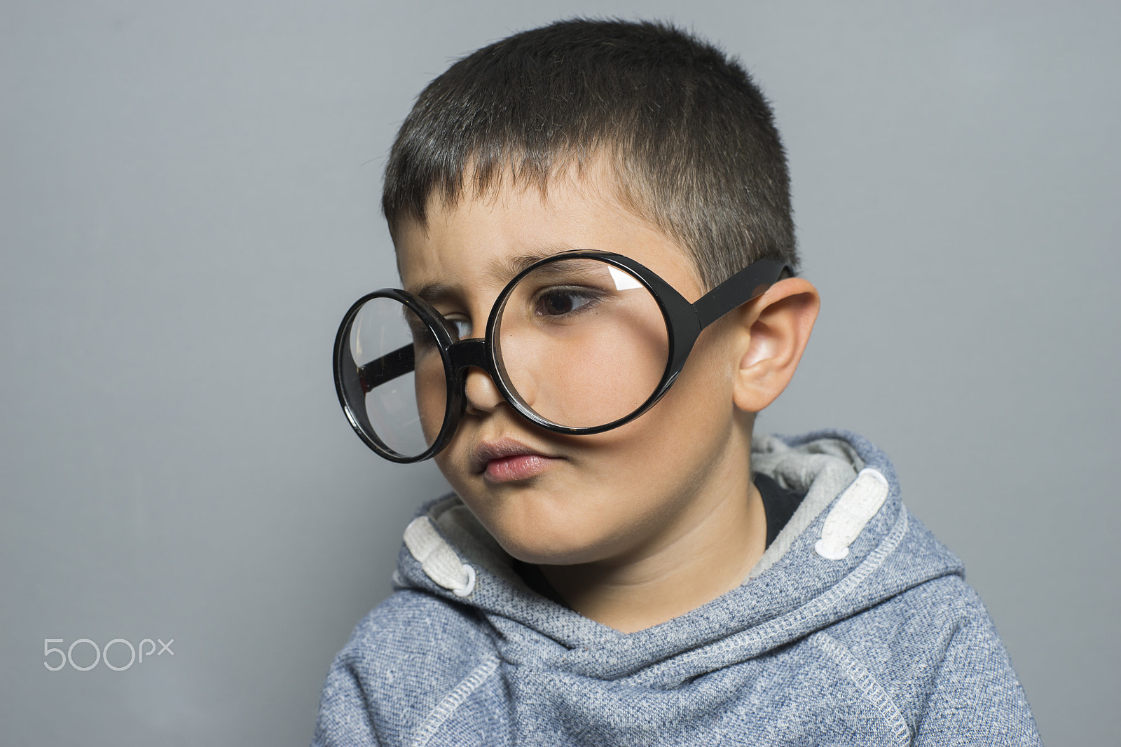 Sony a7 + Sony DT 50mm F1.8 SAM sample photo. Boy with big glasses very serious and thinking photography