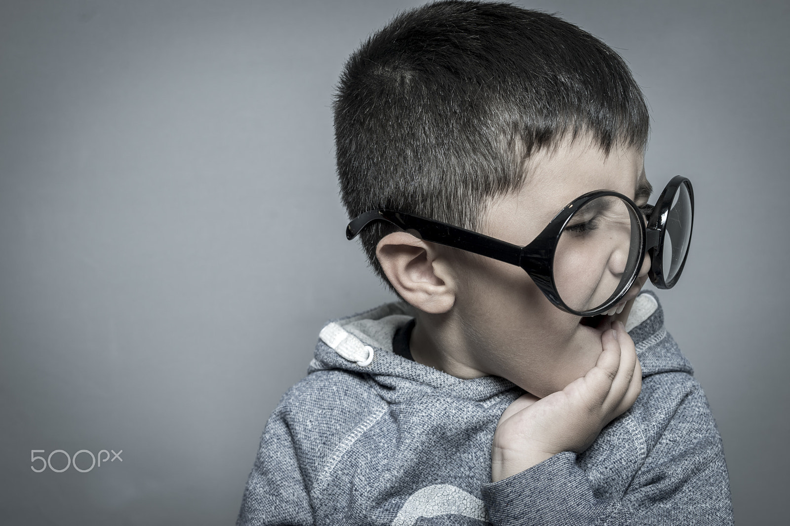 Sony a7 + Sony DT 50mm F1.8 SAM sample photo. Dark-haired young student with big glasses thinking gesture photography