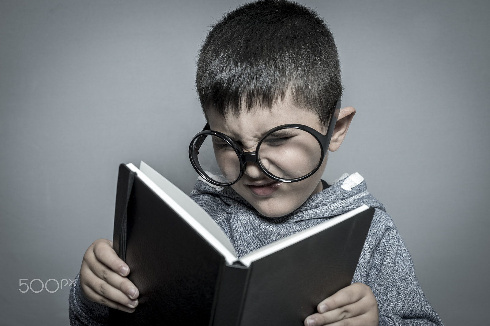 Sony a7 + Sony DT 50mm F1.8 SAM sample photo. Child, dark-haired young student reading a funny book, reading a photography