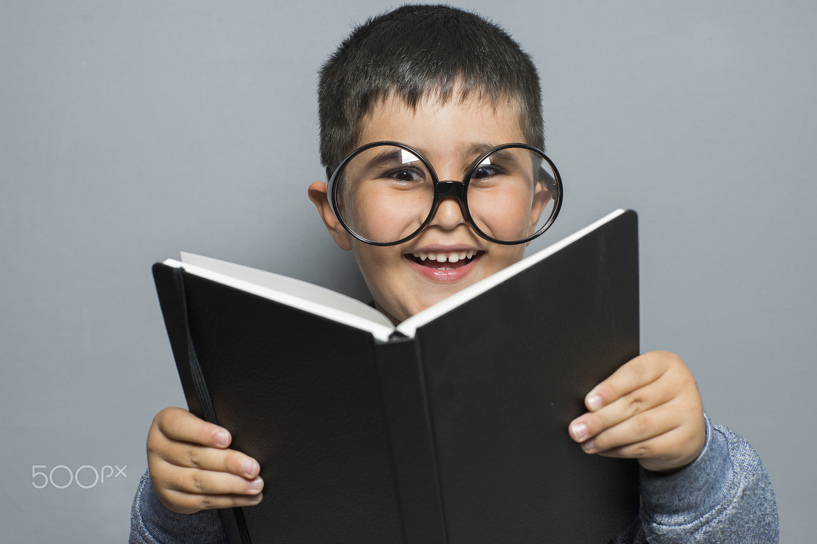 Sony a7 + Sony DT 50mm F1.8 SAM sample photo. Happy learning, dark-haired young student reading a funny book, photography