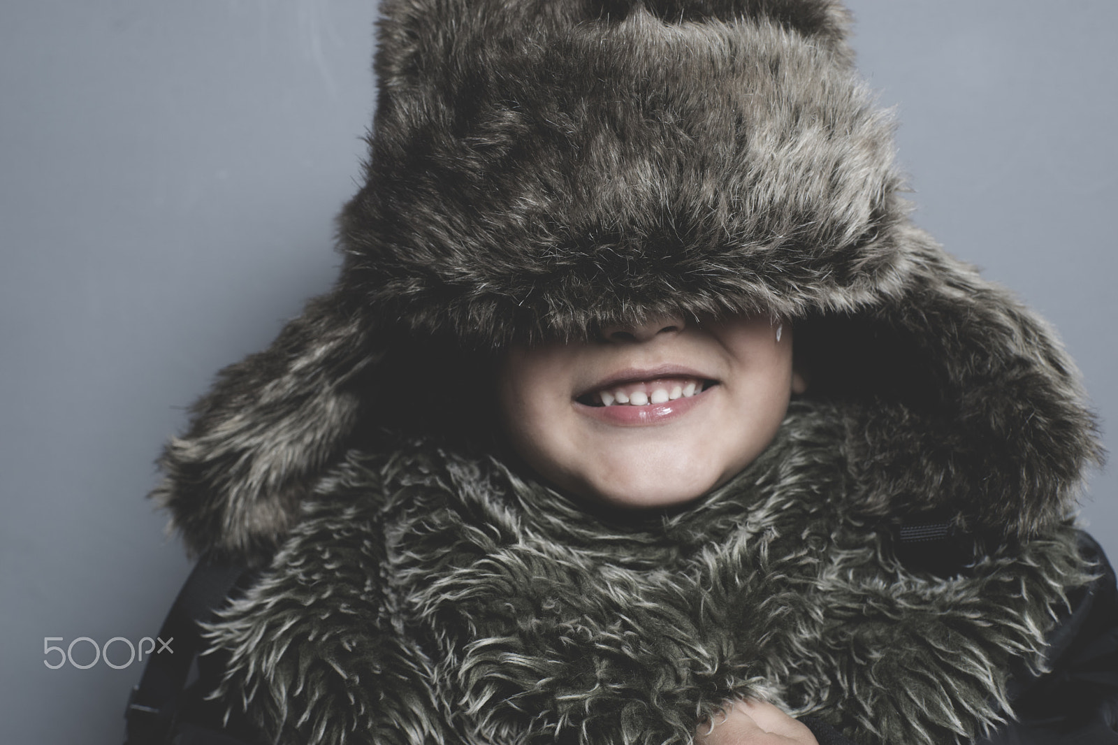 Sony a7 + Sony DT 50mm F1.8 SAM sample photo. Funny child with fur hat and winter coat, cold concept and storm photography