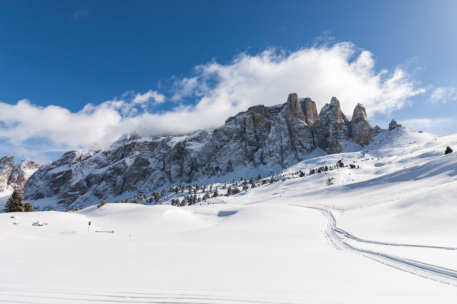 Canon EOS 500D (EOS Rebel T1i / EOS Kiss X3) + Canon EF-S 10-18mm F4.5–5.6 IS STM sample photo. View of the sella group with snow in the italian dolomites photography