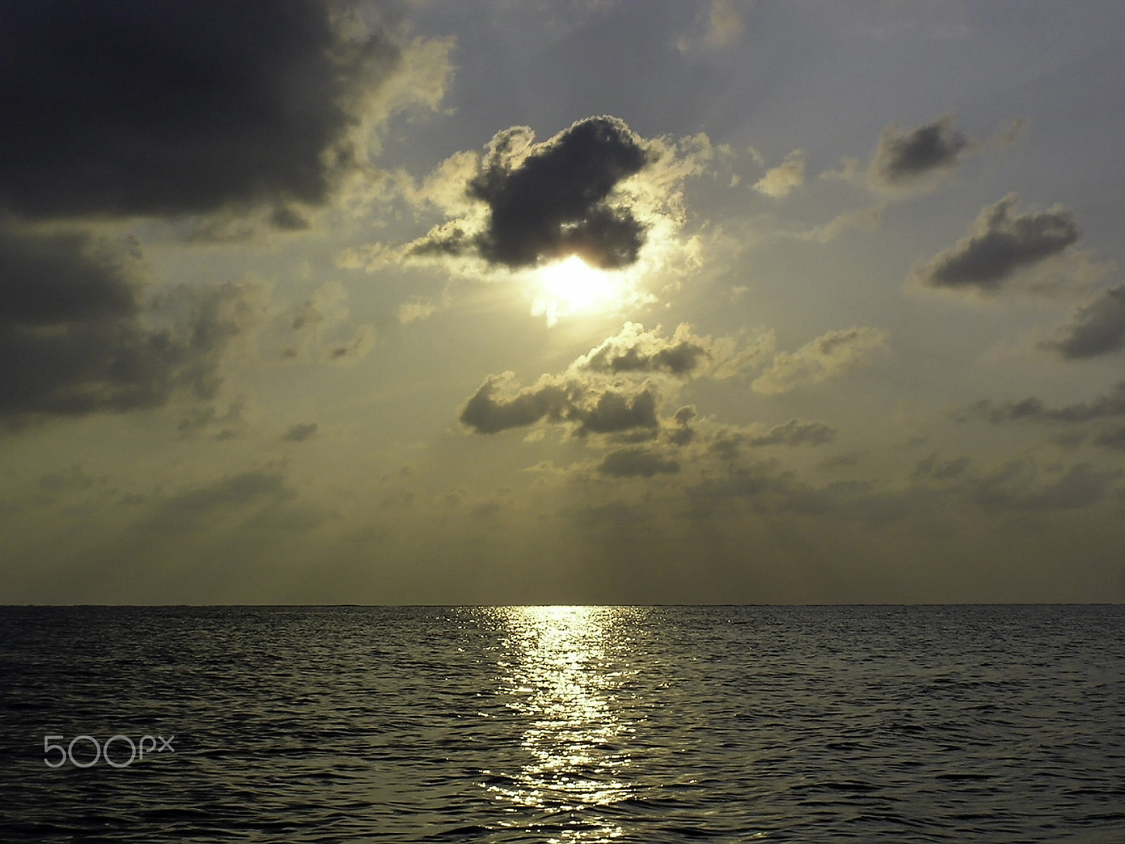 Olympus C750UZ sample photo. Sun shining from behind a cloud at near sunset off the waters of photography