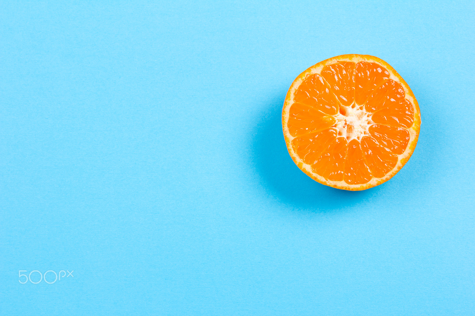 Canon EOS 60D sample photo. Sliced mandarin on blue background photography