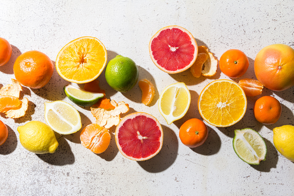 different kinds of citrus on white background by Eight Eight on 500px.com