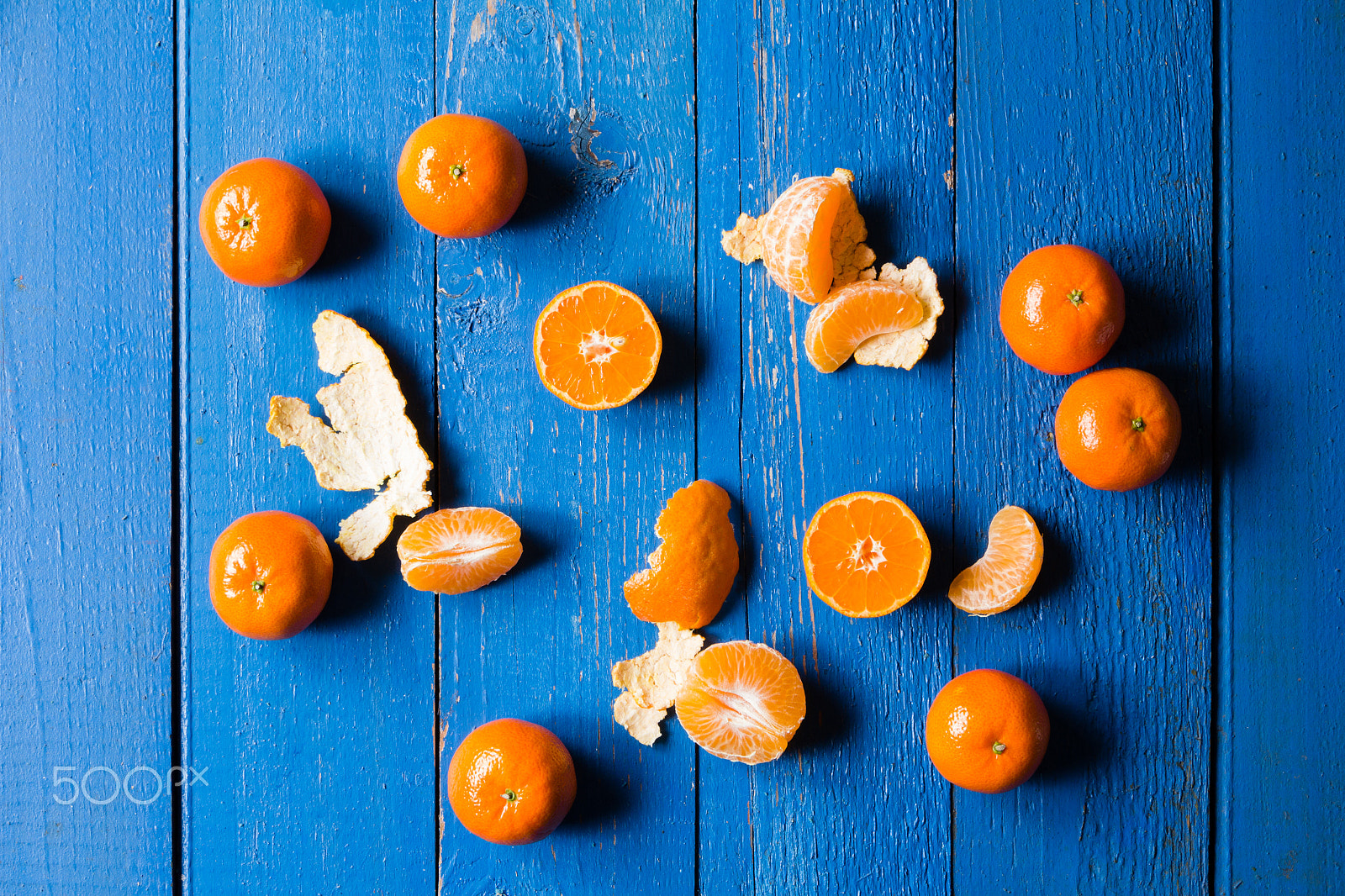 Canon EOS 60D sample photo. Whole, cutted and pilled mandarins on a blue painted wooden background photography