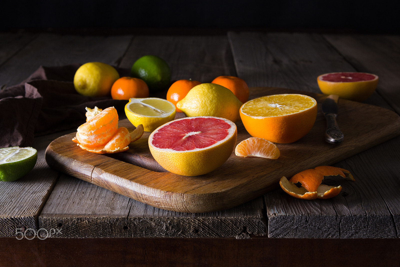 Canon EOS 60D sample photo. Various types of citrus fruit on a dark wooden background photography