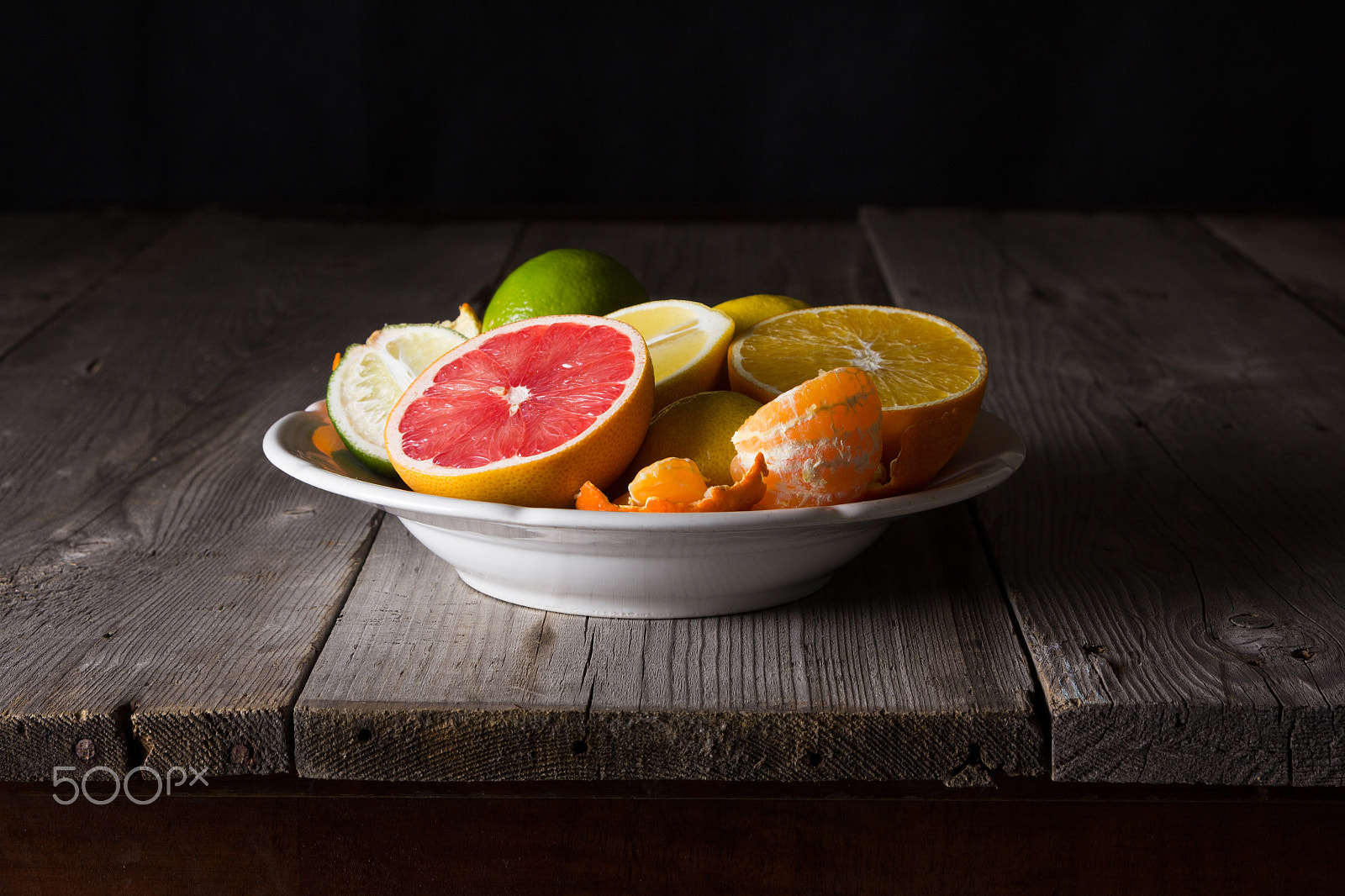 Canon EOS 60D sample photo. Various types of citrus fruit on a dark wooden background photography