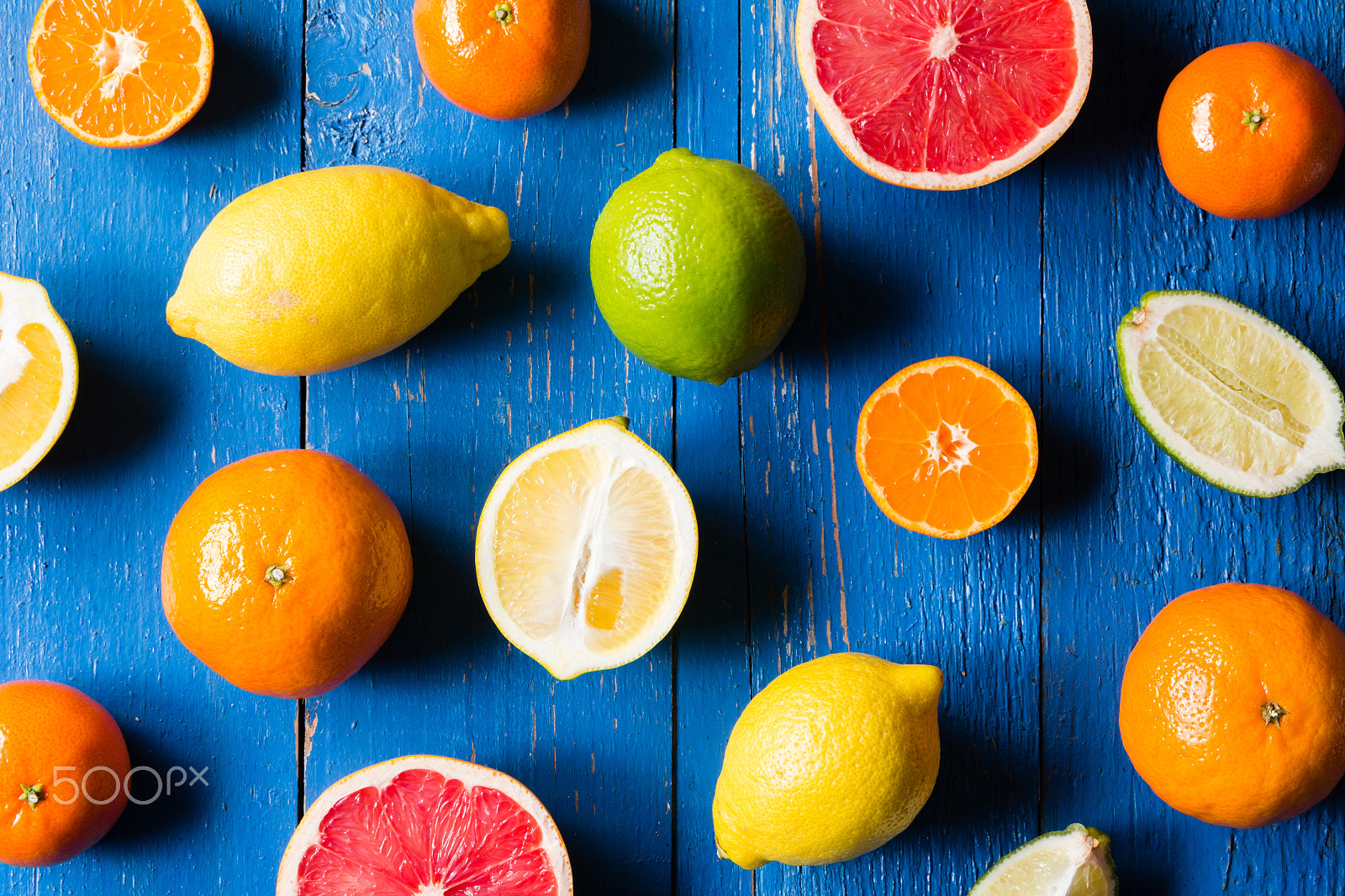 Canon EOS 60D sample photo. Various types of citrus fruit on a blue painted wooden background photography