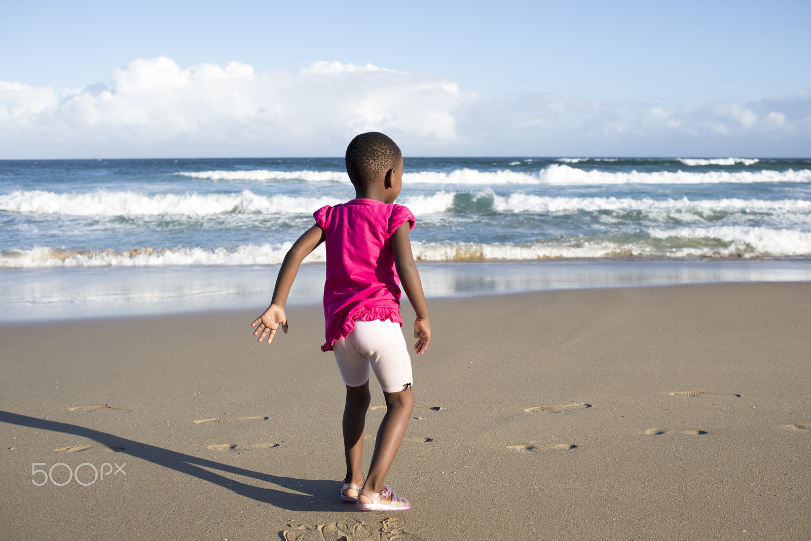 Nikon D600 + Nikon AF Nikkor 35mm F2D sample photo. Little girl in pink by the beach photography