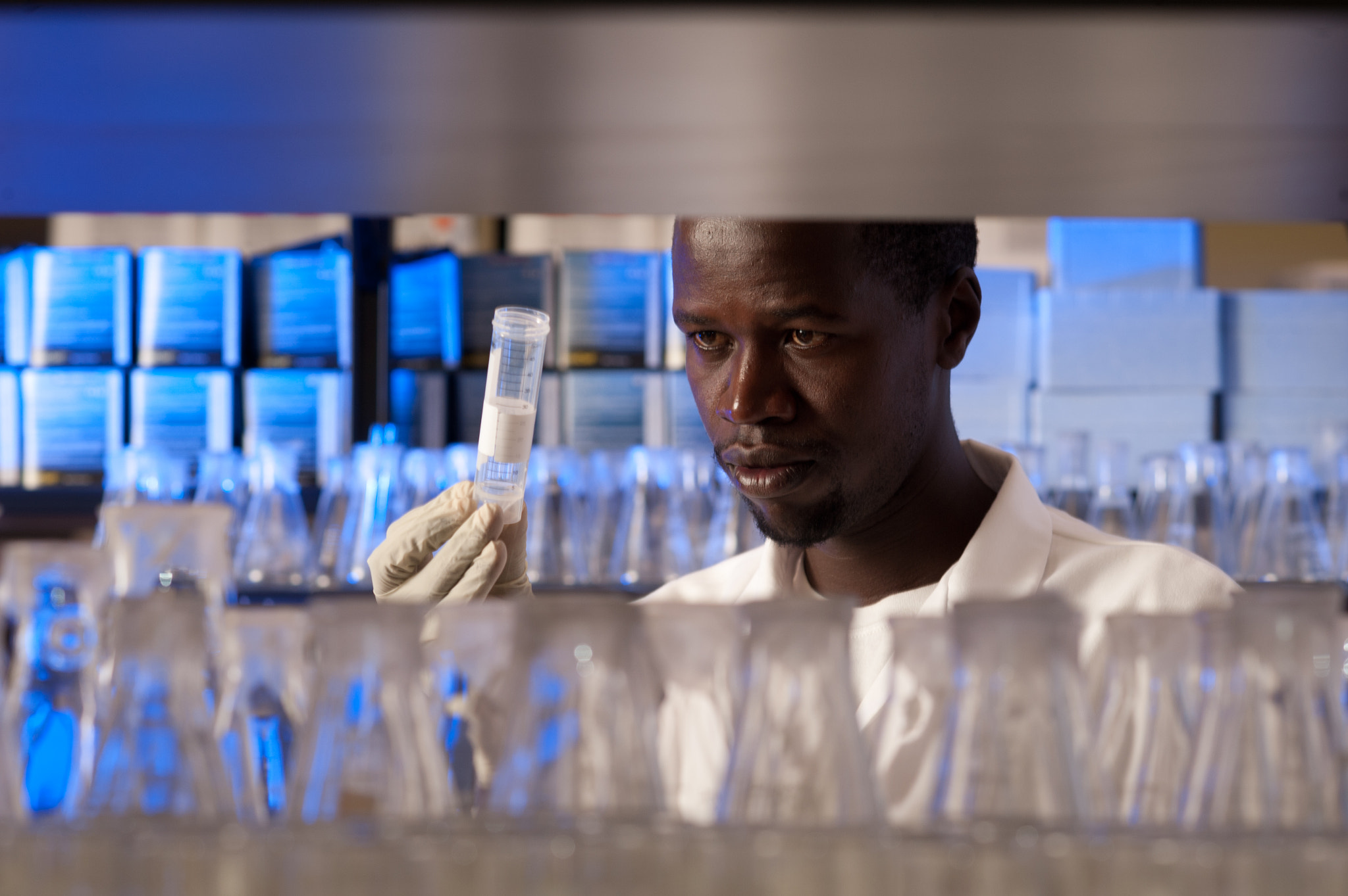 AF DC-Nikkor 135mm f/2 sample photo. Researcher in a lab studying a sample photography