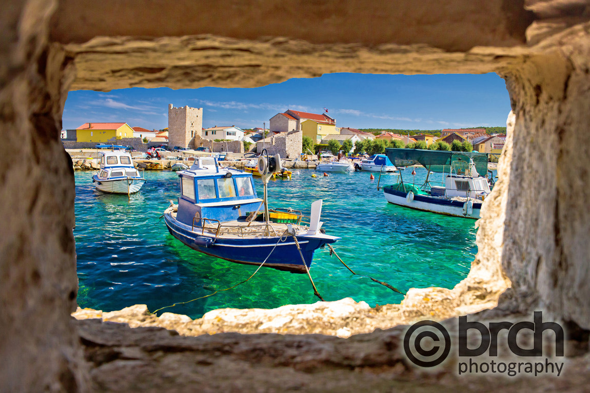 Canon EF-S 10-22mm F3.5-4.5 USM sample photo. Razanac turquoise waterfront through stone window photography