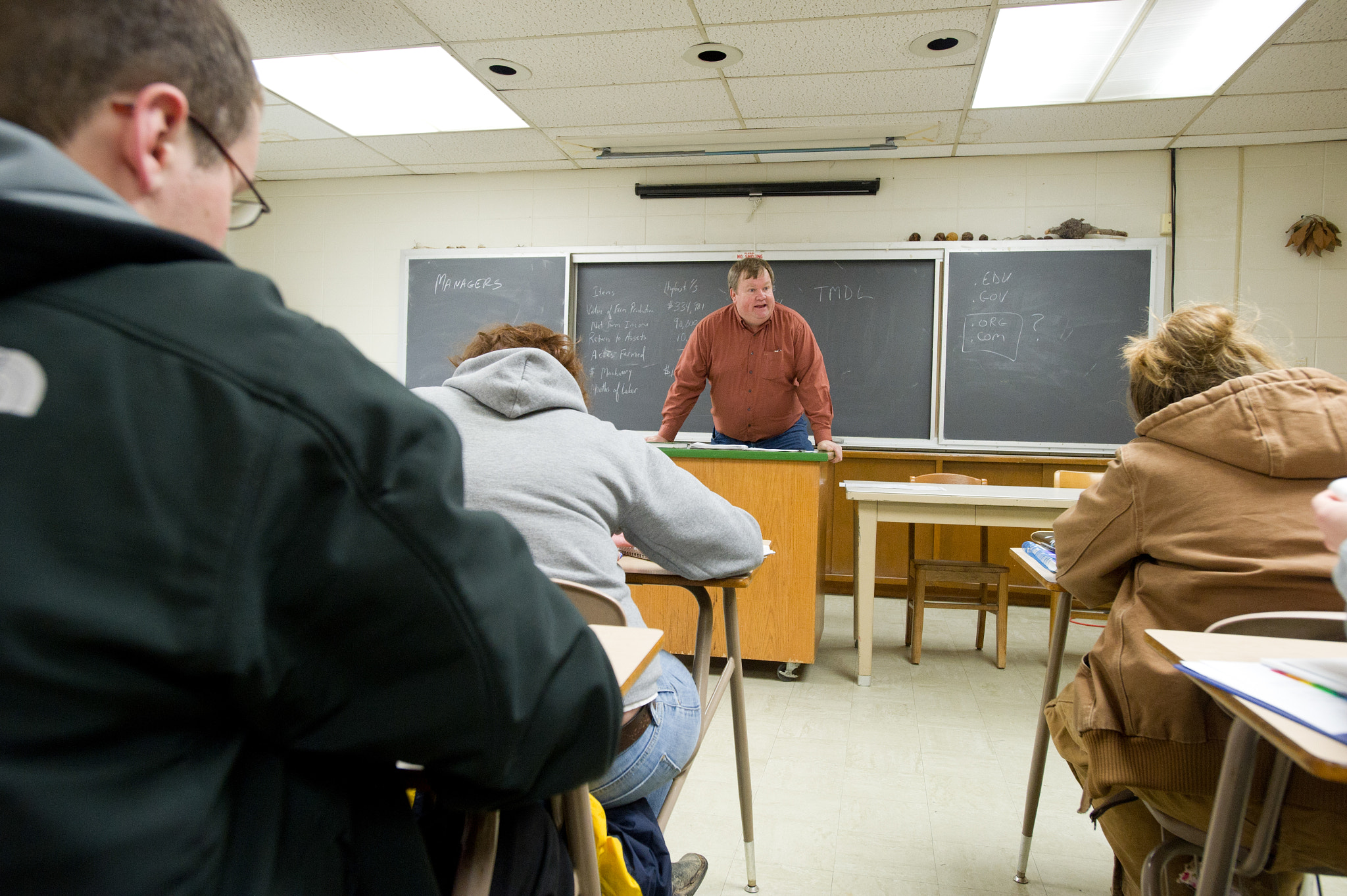Nikon D3S sample photo. Students at a desk and teacher in the front of a classroom photography