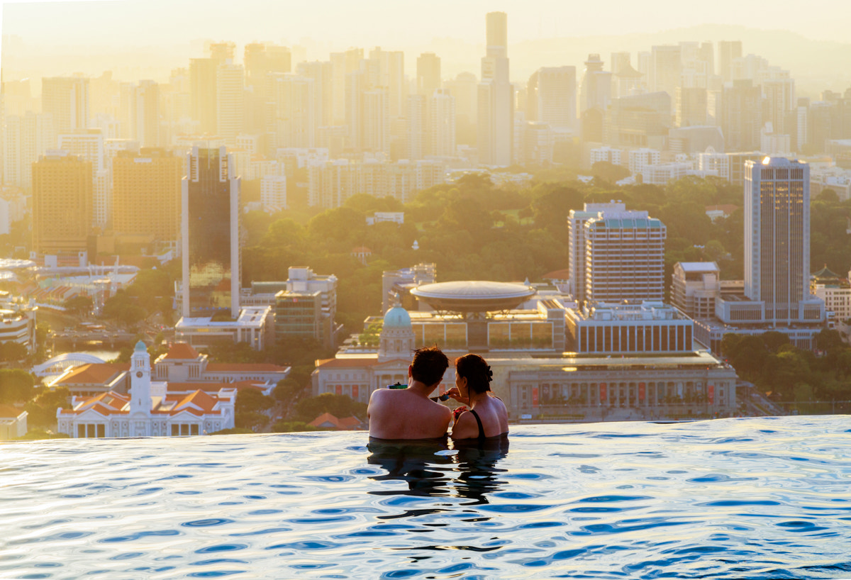 Sony a7R II + Canon EF 24-105mm F4L IS USM sample photo. Tourists enjoying the incredble view of downtown singapore as seen from the infinity pool in the... photography