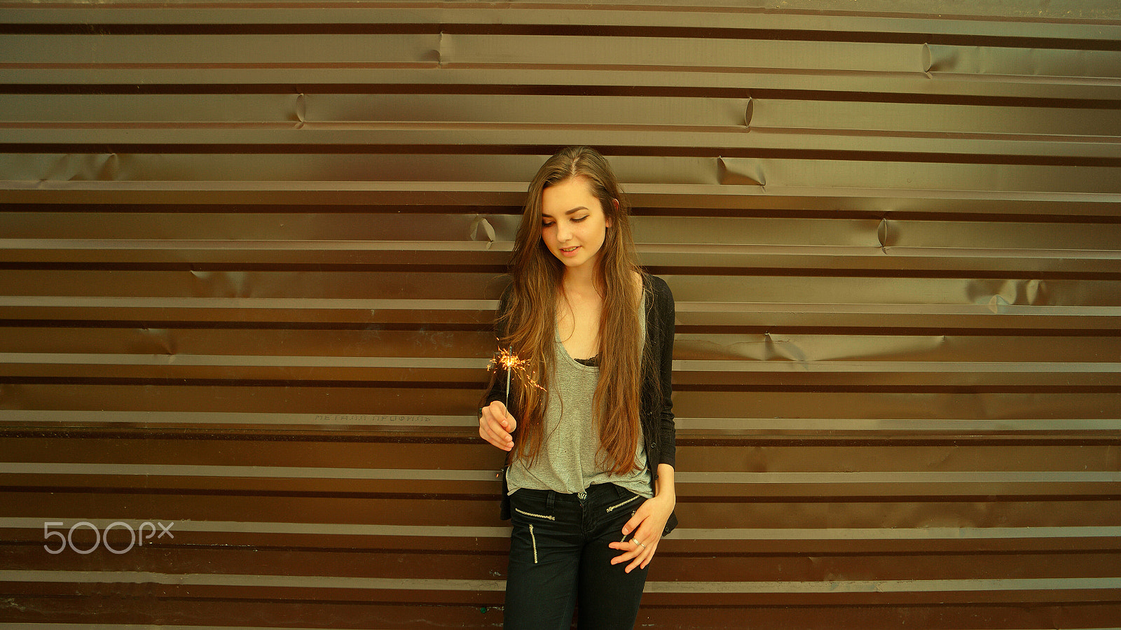 Samsung NX500 + Samsung NX 16-50mm F3.5-5.6 Power Zoom ED OIS sample photo. Happy teen girl with sparkler on metal fence background with copyspace photography