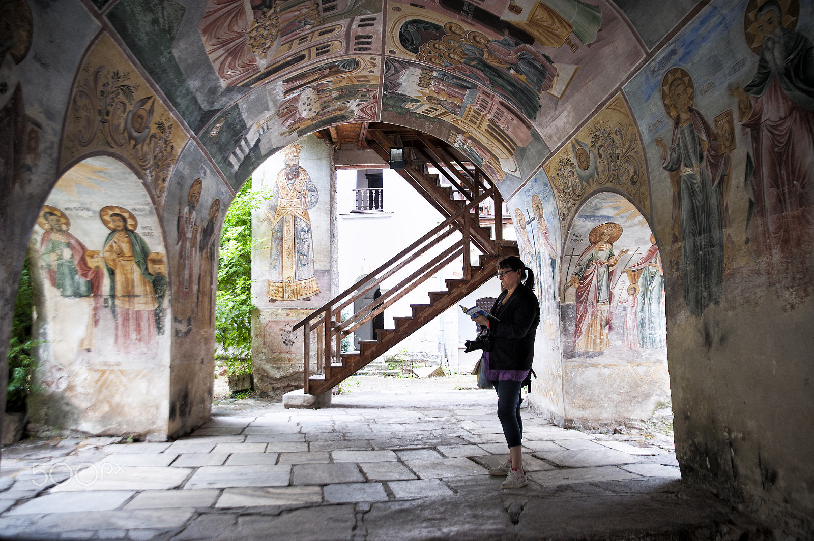 Nikon D700 + Tamron SP 24-70mm F2.8 Di VC USD sample photo. Tourist under polychrome arches of a monastery photography