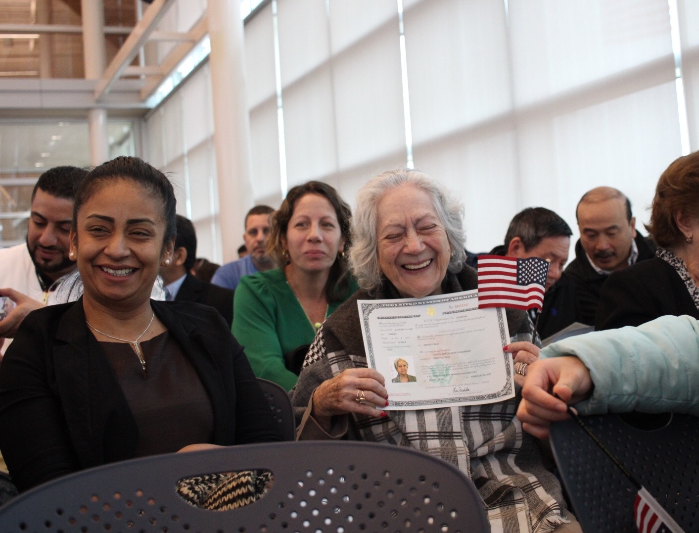 Canon EF-S 24mm F2.8 STM sample photo. Emotional moment as she receives her naturalization certificate. photography